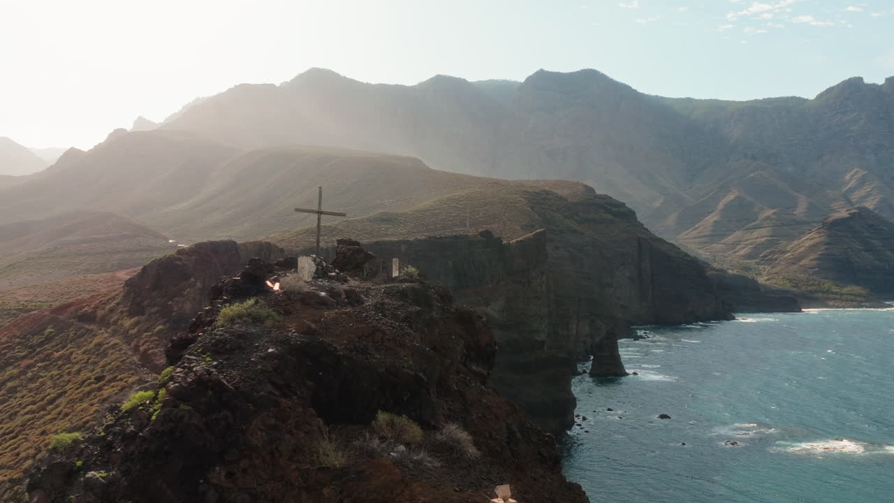 Observation deck reveal Gran Canaria housing complex luxury hotel villas, bungalows on Canary Island with wind turbines on mountains, Drone shot