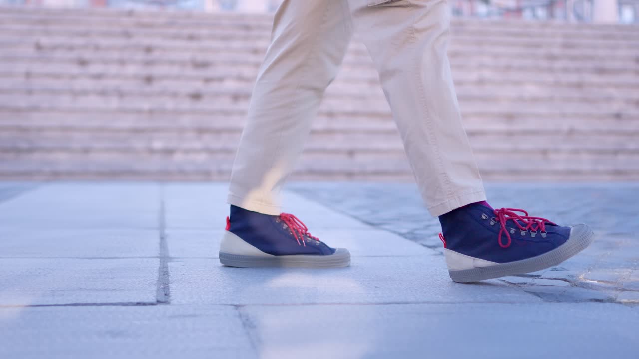 Close-up of Person's Feet Walking in Blue Sneakers