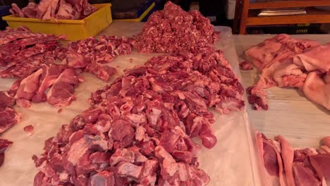 assorted cuts of meat displayed on butcher's table