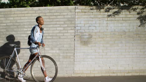 woman walking with bicycle in city street 4k