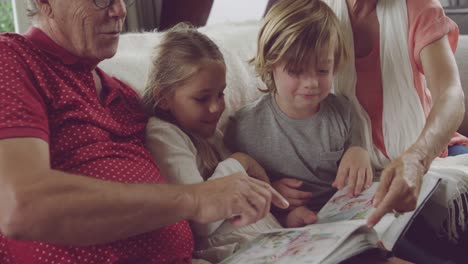 senior couple at home with grandchildren