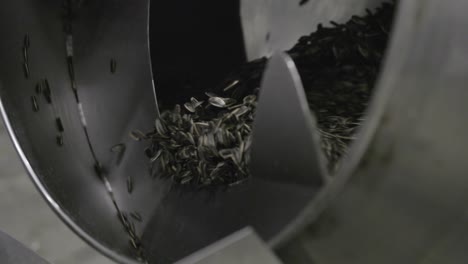 close up shot of a spinning machine mixing sunflower seed