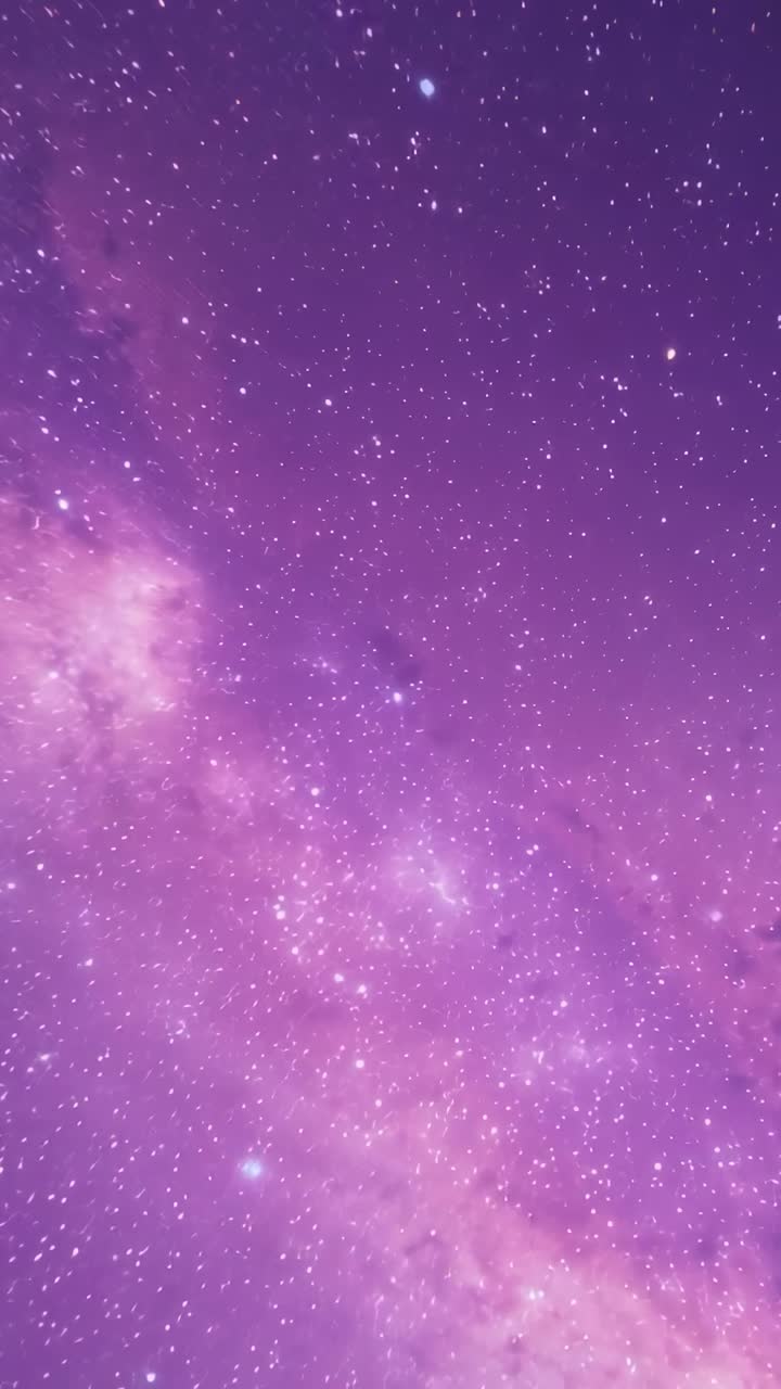 Vertical video: Panning camera upward at night, revealing purple milky way cluster and moon orb