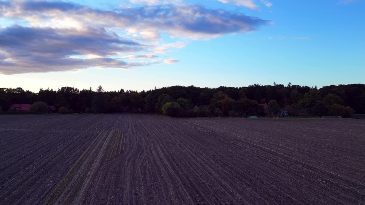the edge of a forest bordering a plowed field in germany. Unbelievable aerial view flight panorama overview drone