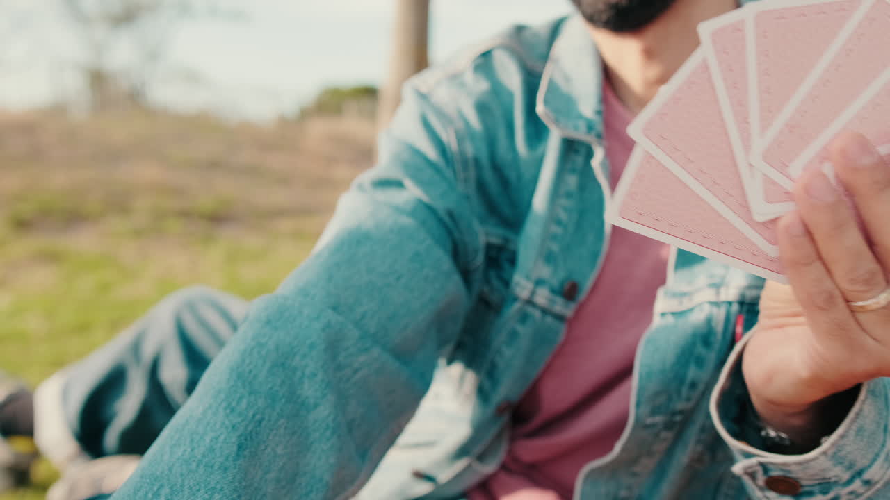 Friends Playing Cards at a Picnic