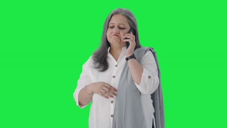 Indian-senior-businesswoman-talking-on-call-Green-screen