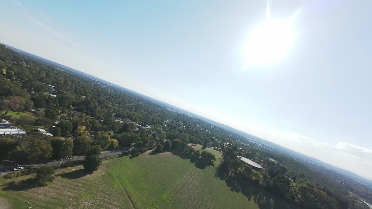 Drone footage blending urban living and woodland scenery