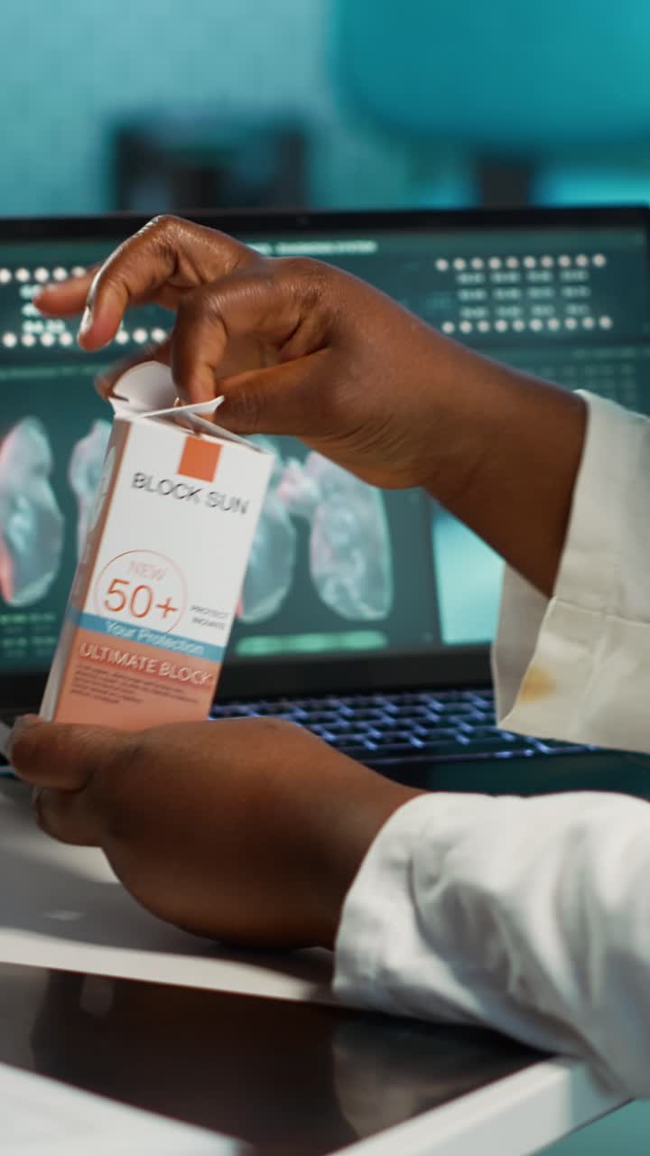 Hands Holding and Opening a Sunscreen Box
