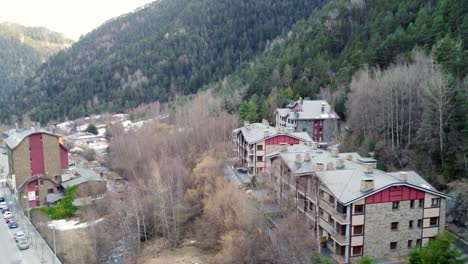 fast drone aerial descending through mountain valley town surrounded by trees