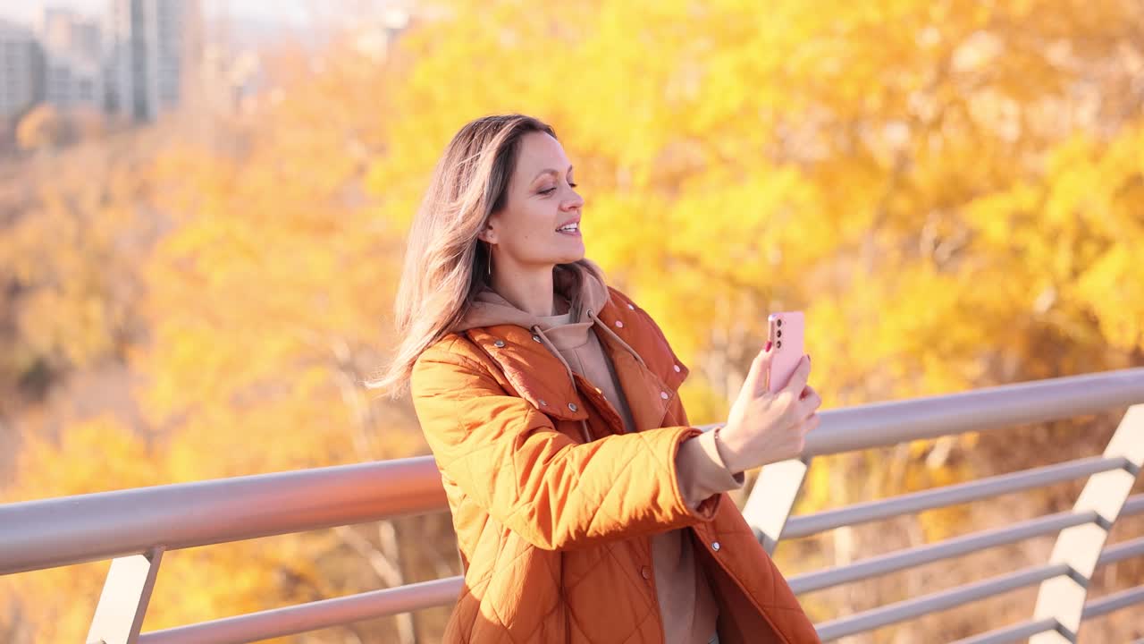 Woman taking selfie in autumn
