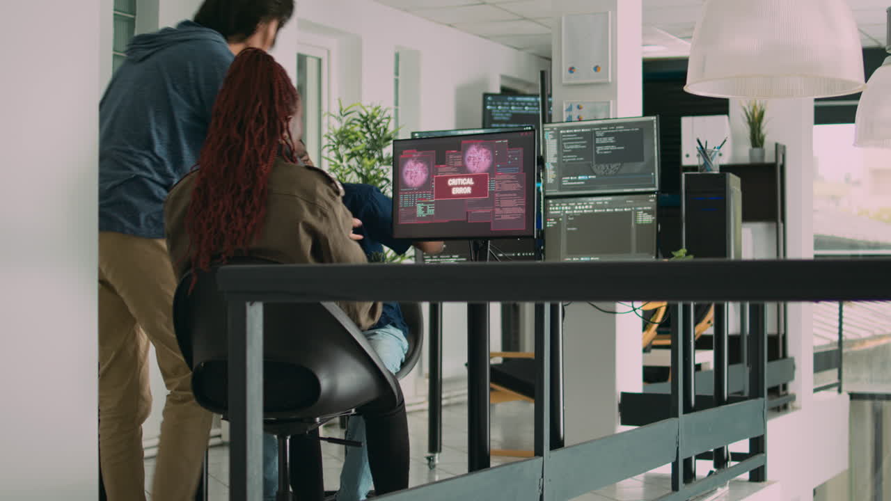 Diverse group of app developers working with hacked computer