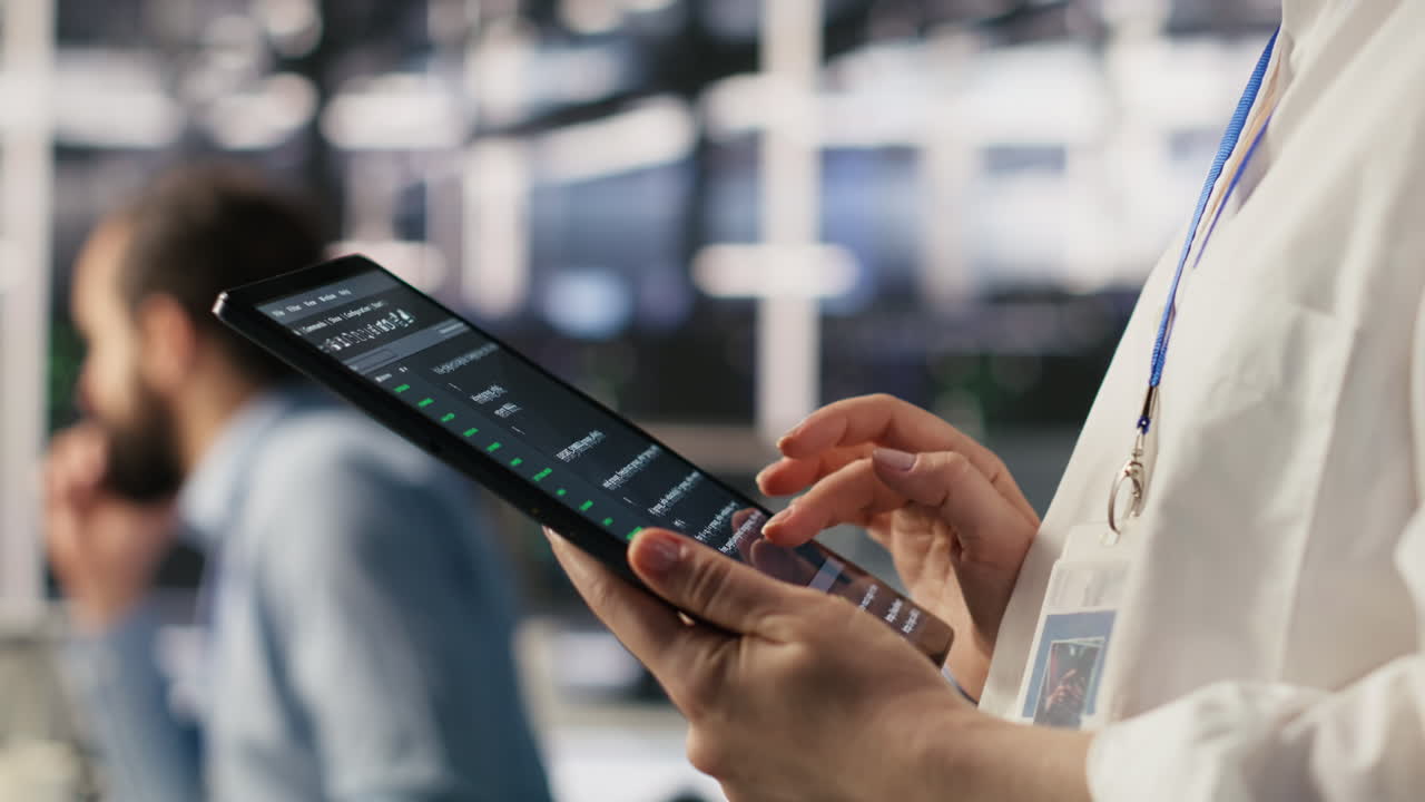 Vertical video Close up of data center system administrator coding on tablet