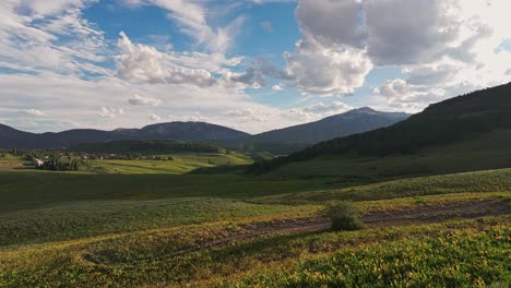 aerial over green hills and meadows near the crested butte mountain, colorado, usa