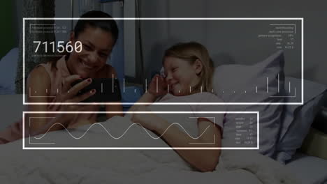 Animación-De-Números,-Gráfico-Sobre-Una-Madre-Diversa-Mostrando-Un-Video-En-Un-Teléfono-Celular-A-Su-Hija-En-El-Hospital