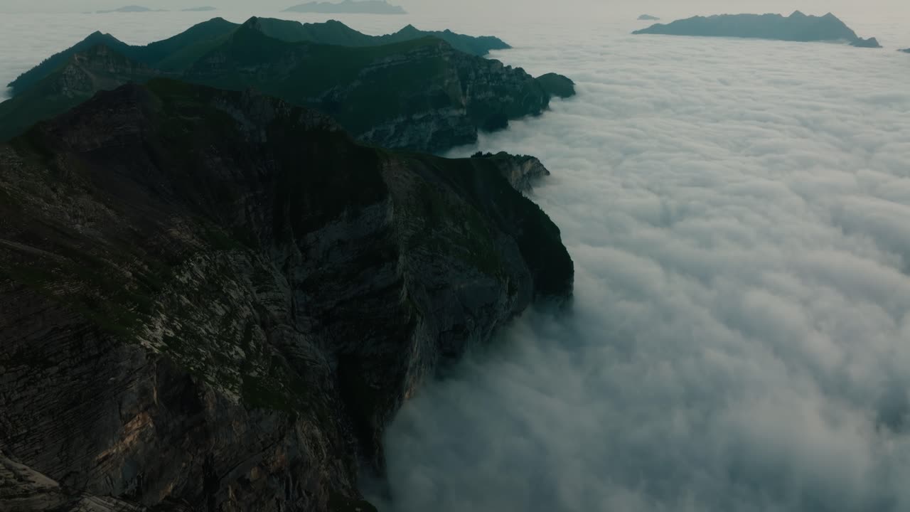 Sunrise aerial of alpine ridge and dramatic cloud inversion in Melchsee-Frutt, Switzerland