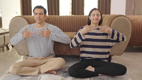 Indian-couple-doing-breathe-in-breathe-out-exercise
