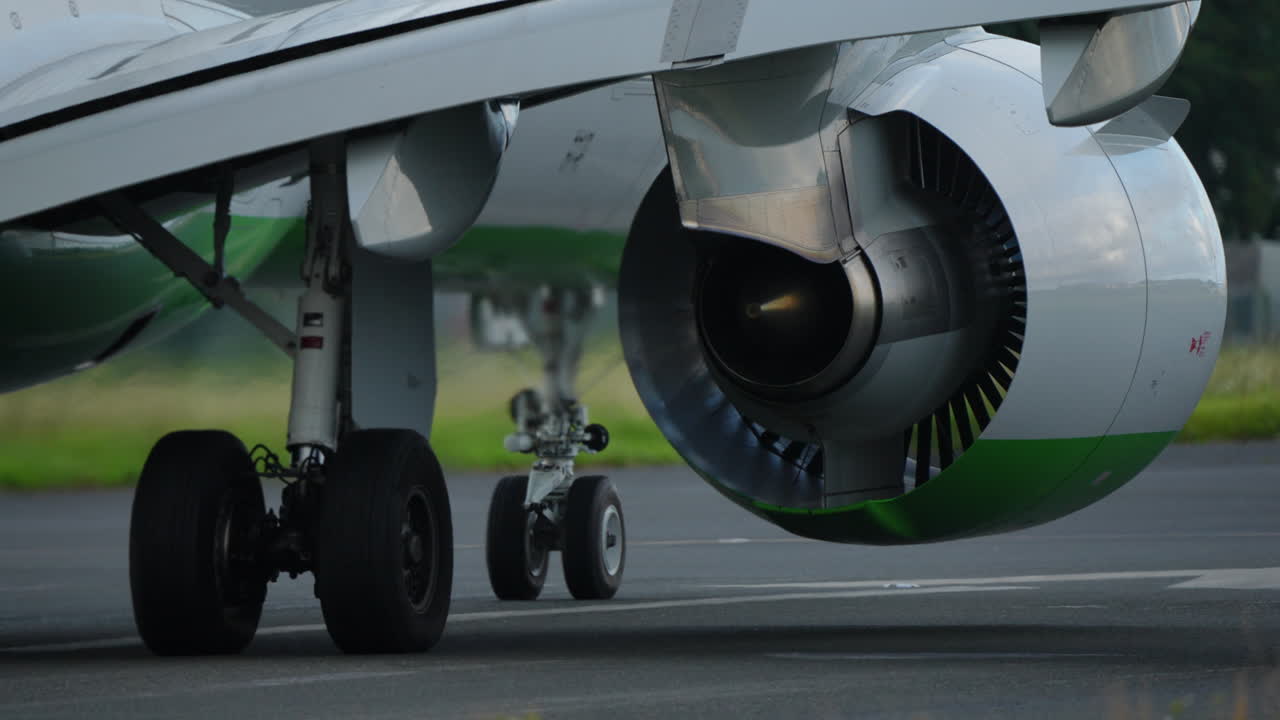 Close-up view of aircraft landing gear and jet engine