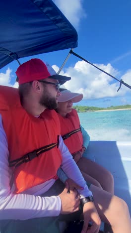 safe couple inside motorboat sailing caribbean sea with life jackets, los roques