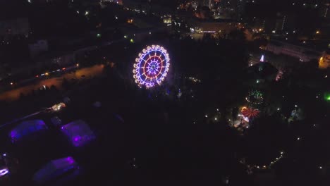 aerial view of illuminated ferris wheel at night
