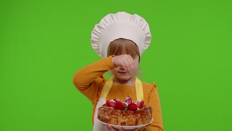 Child-girl-kid-dressed-as-cook-chef-sprinkle-strawberry-pie-with-icing-sugar,-chroma-key-background