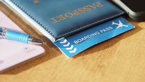 Passport and Boarding Pass on Wooden Table