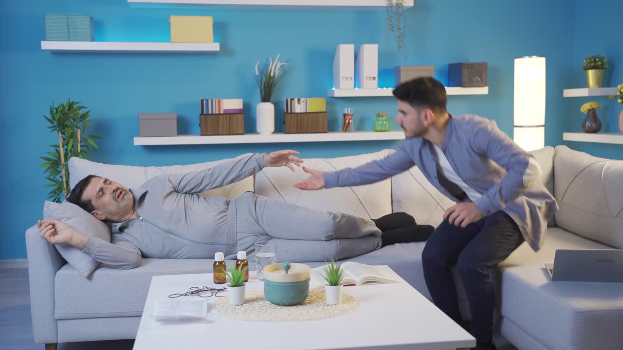 아들이 아픈 아버지가 일어나도록 도와주고 있습니다.