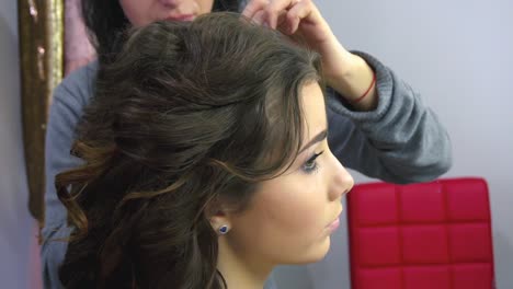 Beautiful-woman-having-her-hair-curled-in-barber-salon