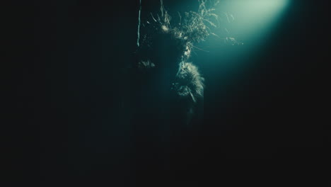 a creepy witch rises her head during the night storm