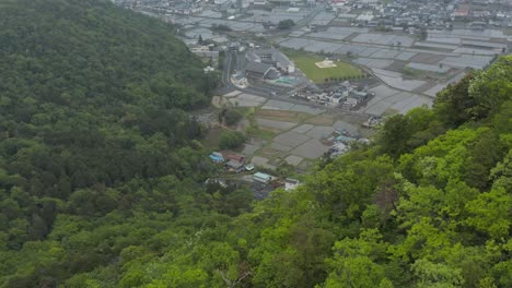 Yokaichi-in-Shiga-prefecture-Japan,-Aerial-tilt-from-mountains-to-reveal-city