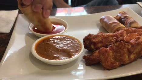 Eating-spring-rolls-with-sauce-Close-up-Personal-perspective