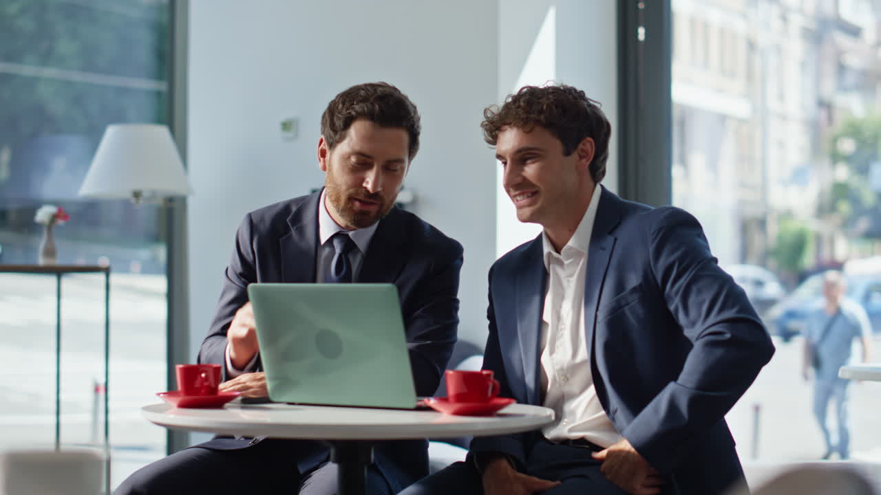 Colleagues video calling laptop online at cozy panoramic restaurant closeup