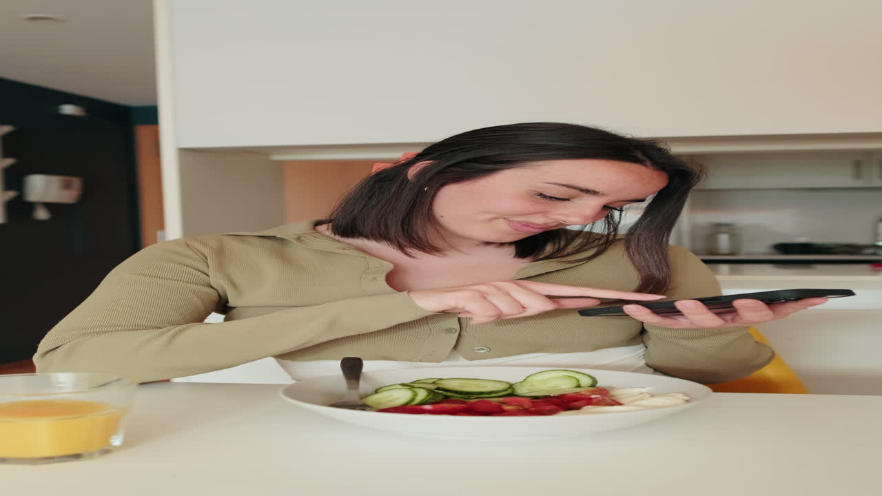 Woman Using Phone While Eating Breakfast