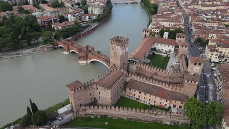 drone rotating shot over castelvecchio with final view of verona city - italy