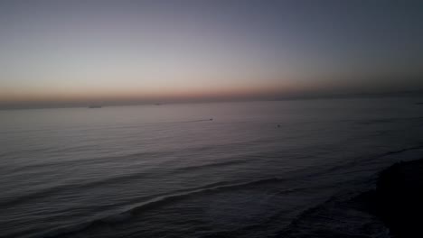 Aerial-view-towards-the-Guincho-beach,-sunrise,-in-Portugal---approaching,-drone-shot