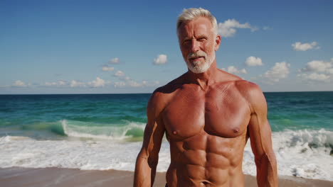muscular senior man posing on a sunny beach