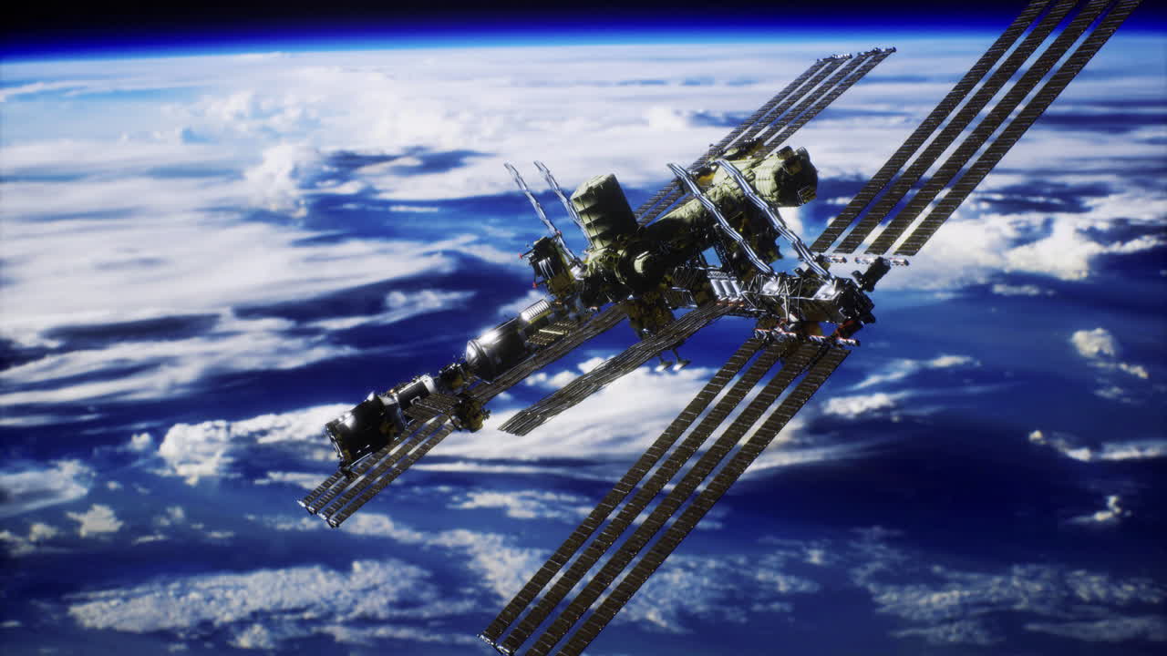 International space station orbiting earth above the clouds during daylight