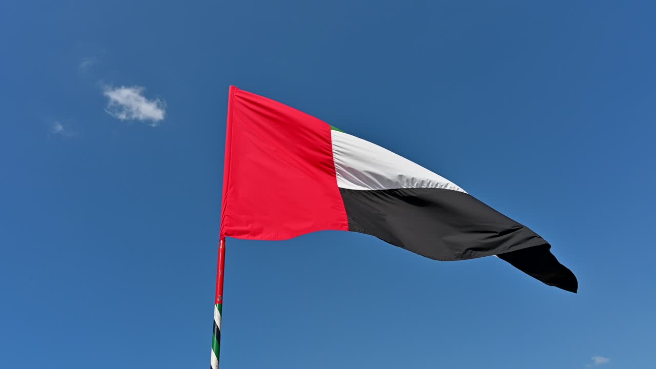 4k Footage: National Flag of United Arab Emirates on a Pole Waving in Wind against Clear Blue Sky, A Part UAE National Day Celebrations