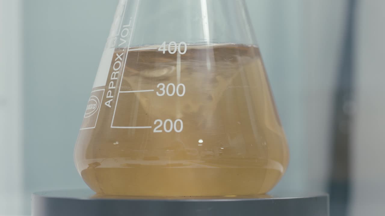 Stirring Test Tubes containing chemical liquids while working in a Modern Research Laboratory