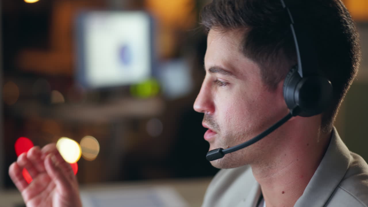 Man with headset providing customer service at night