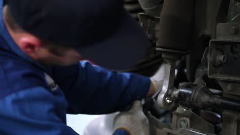 truck mechanic working on suspension system