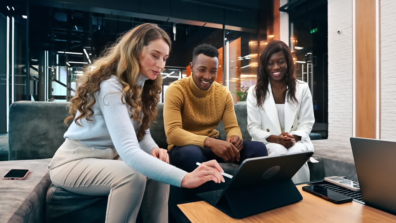 Multiraciale groep werknemers in een kantoor die een zakelijk gesprek voeren met behulp van een tablet. Slow motion