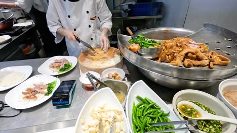 chef assembling stewed pork leg rice meal