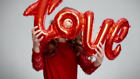 smiling woman holding word love