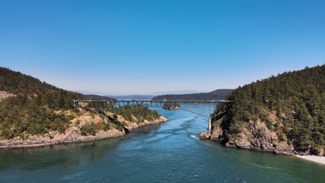 Aerial-rising-shot-of-vehicles-crossing-the-Deception-Pass-in-Washington