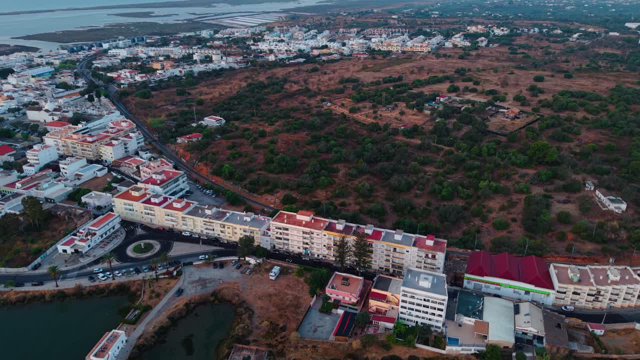 aerial shot revealing Fuseta at sunrise, a typical portuguese fishing village in Algerve region near Faro and Ria Formosa natural park, Portugal