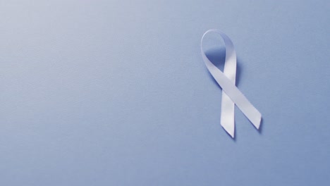 video of pale blue prostate cancer ribbon on blue background