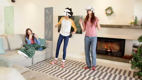 women friends enjoying virtual reality games at home during christmas celebration