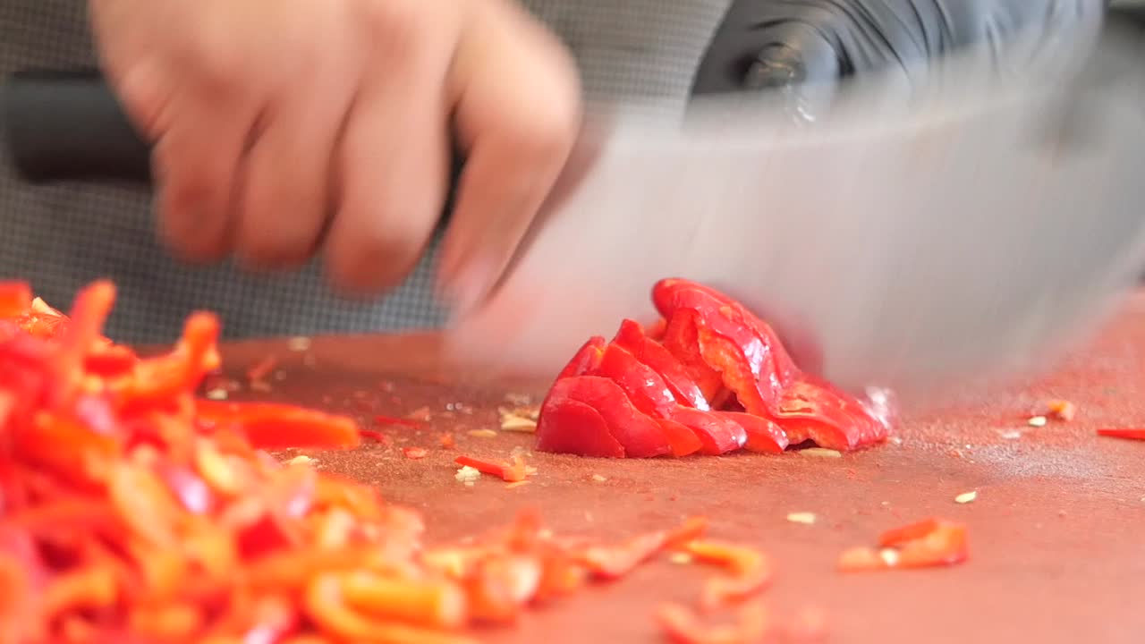 Slicing red peppers for cooking