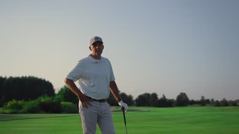 Senior-posing-golf-course-outdoors.-RIch-man-looking-camera-on-golfing-field.