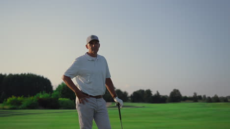 senior posing golf course outdoors. rich man looking camera on golfing field.